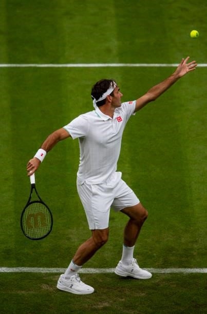 Roger Federer of Switzerland serves against Adrian Mannarino of France in the first round of the gentleman's singles, during Day Two of The...