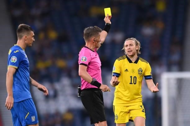 Sweden player Emil Forsberg is yellow carded by referee Daniele Orsato during the UEFA Euro 2020 Championship Round of 16 match between Sweden and...