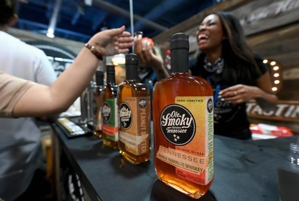 Guests are seen at Ole Smokey booth and bar during Day 2 of the 35th Annual Nightclub & Bar Show and World Tea Expo at the Las Vegas Convention...