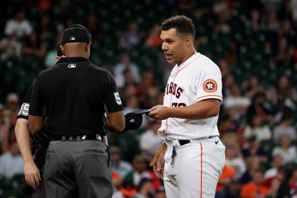Umpire CB Bucknor checks Andre Scrubb of the Houston Astros following the second inning for substances against the Baltimore Orioles at Minute Maid...