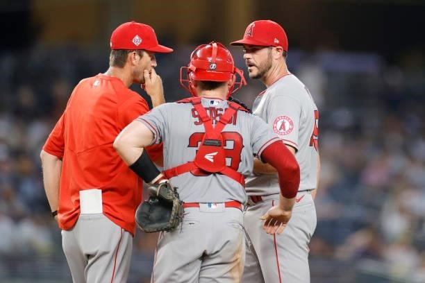 James Hoyt, Max Stassi, and pitching coach Matt Wise of the Los Angeles Angels meet on the mound during the fourth inning against the New York...