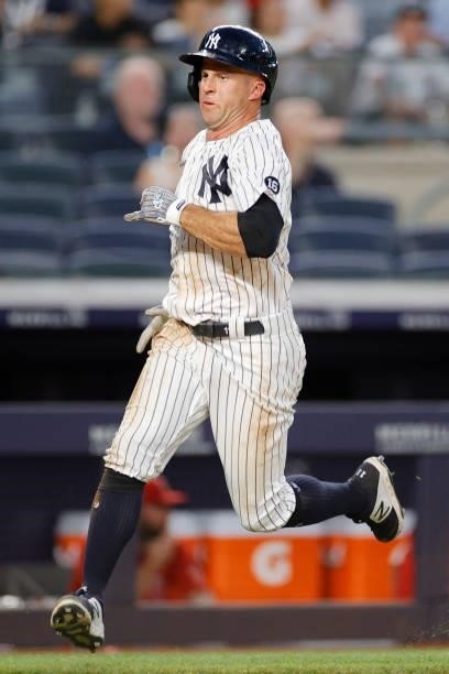 Brett Gardner of the New York Yankees runs to first to score on an RBI double hit by Gary Sanchez during the fourth inning against the Los Angeles...