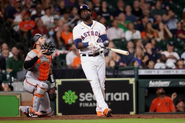 Yordan Alvarez of the Houston Astros reacts to hitting a pop fly to end the sixth inning leaving two men on base ahead of Austin Wynns of the...
