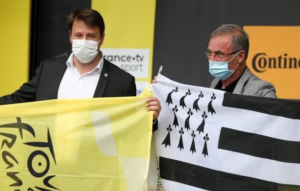 President of Brittany Loïg Chesnais-Girard and five time Tour de France winner Bernard Hinault holding the flag of Brittany during the podium...