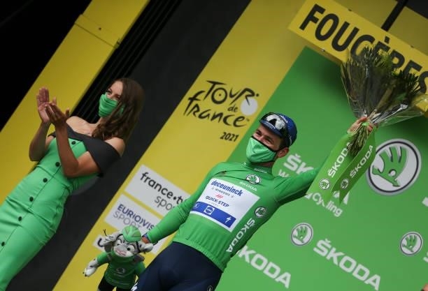 Stage winner Mark Cavendish of Great Britain and Deceuninck - Quick Step wears the green jersey of best sprinter during the podium ceremony of stage...
