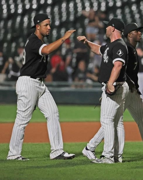 Jose Abreu and Liam Hendriks of the Chicago White Sox celebrate a win over the Minnesota Twins at Guaranteed Rate Field on June 29, 2021 in Chicago,...