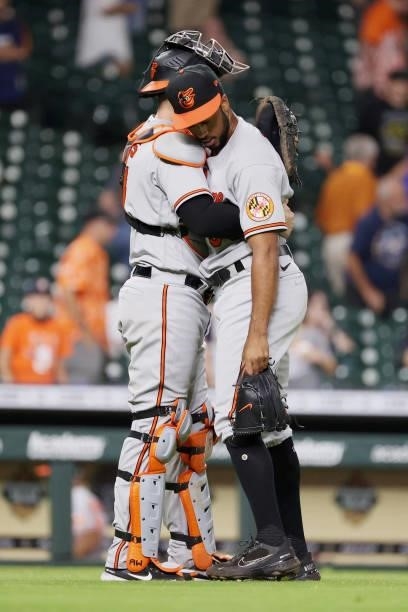 Dillon Tate of the Baltimore Orioles hugs Austin Wynns after defeating the Houston Astros 13-3 at Minute Maid Park on June 29, 2021 in Houston, Texas.