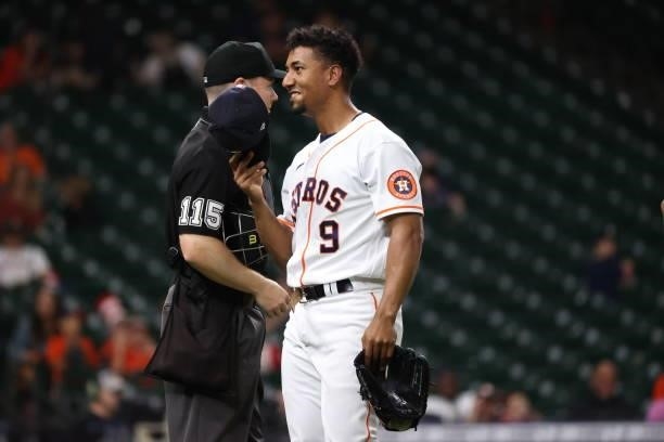Robel Garcia of the Houston Astros walks past umpire Junior Valentine after pitching during the ninth inning against the Baltimore Orioles at Minute...