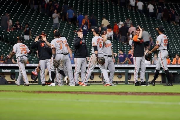 Baltimore Orioles high five after defeating the Houston Astros 13-3 at Minute Maid Park on June 29, 2021 in Houston, Texas.