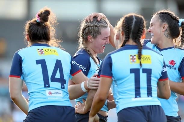 Arabella McKenzie of the Waratahs celebrates her try during the round three Super W match between the NSW Waratahs and the ACT Brumbies at Coffs...