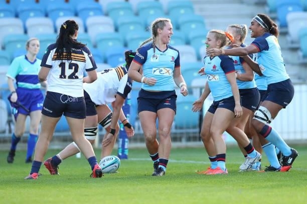 Arabella McKenzie of the Waratahs celebrates scoring a try during the round three Super W match between the NSW Waratahs and the ACT Brumbies at...