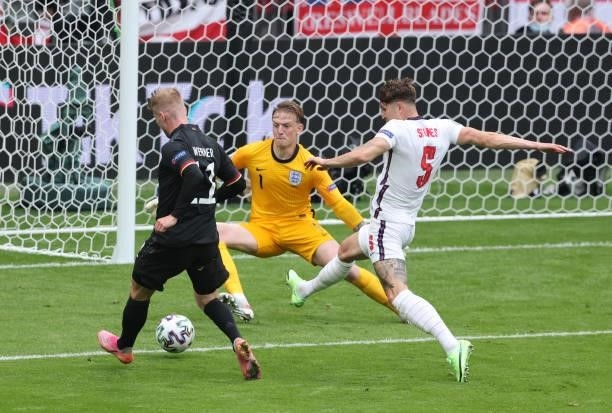 Timo Werner of germany vies with Jordan Pickford of England and John Stones of England during the UEFA Euro 2020 Championship Round of 16 match...