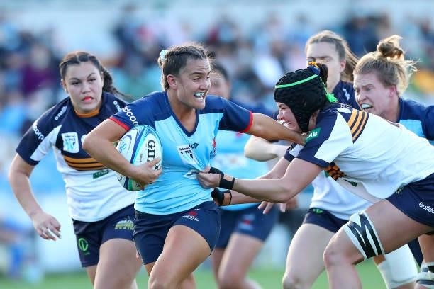 Katrina Barker of the Waratahs runs with the ball and is tackled by Michaela Leonard of the Brumbies during the round three Super W match between the...