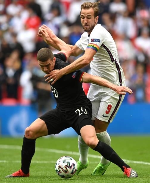 Harry Kane of England battles for possession with Robin Gosens of Germanyduring the UEFA Euro 2020 Championship Round of 16 match between England and...