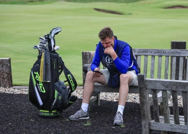Jack Forgan of England reflects on a bench by the clubhouse after his brother Sam Forgan had holed a putt on his final hole in his second round to...