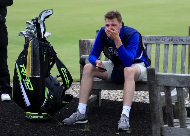 Jack Forgan of England reflects on a bench by the clubhouse after his brother Sam Forgan had holed a putt on his final hole in his second round to...