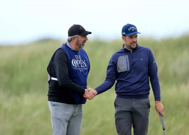 Jordan Godwin of England shakes hands with his caddie on the ninth hole in his second round during Final Qualifying for the 149th Open at Prince's...
