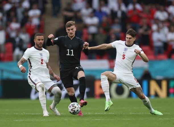Timo Werner of Germany is challenged by Kyle Walker and John Stones of England during the UEFA Euro 2020 Championship Round of 16 match between...
