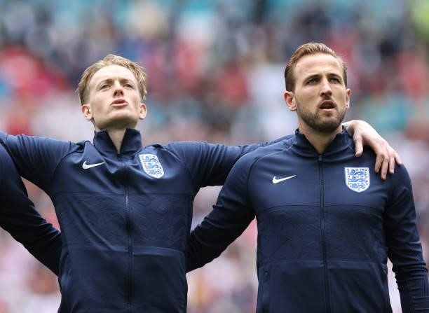 Jordan Pickford and Harry Kane of England sing the national anthem prior to the UEFA Euro 2020 Championship Round of 16 match between England and...
