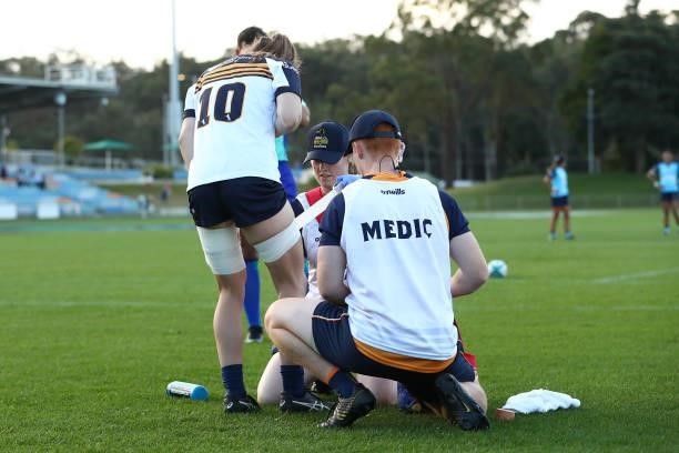 Brumbies player receives medical attention during the round three Super W match between the NSW Waratahs and the ACT Brumbies at Coffs Harbour...