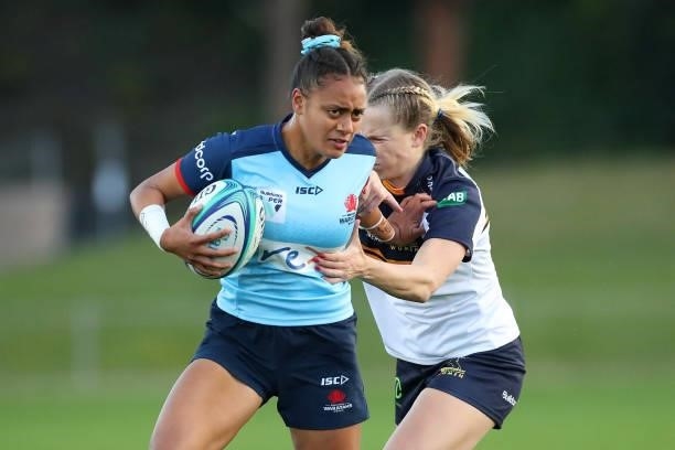 Georgina Tuipulotu of the Waratahs is tackled by Hailey Derera of the Brumbies during the round three Super W match between the NSW Waratahs and the...