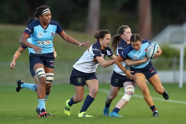 Margot Vella of the Waratahs is tackled during the round three Super W match between the NSW Waratahs and the ACT Brumbies at Coffs Harbour...