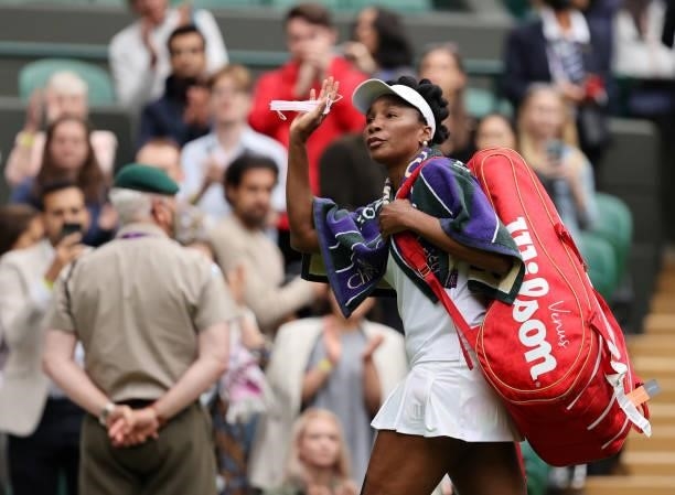 Venus Williams of The United States waves to the crowd as she walks off the court after loosing her Ladies' Singles Second Round match against Ons...
