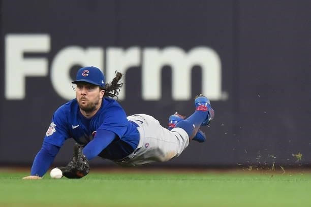Jake Marisnick of the Chicago Cubs is unable to catch a single by Jace Peterson of the Milwaukee Brewers in the second inning at American Family...