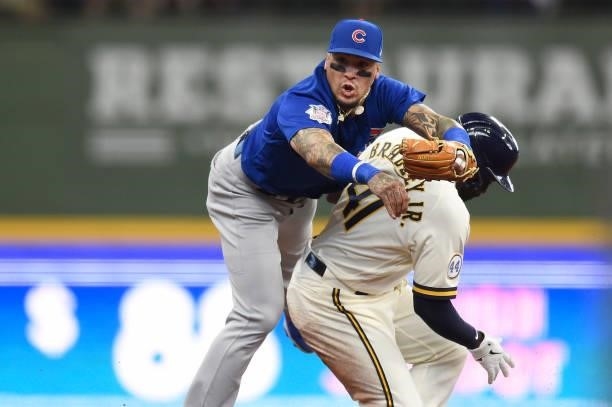 Javier Baez of the Chicago Cubs forces out Jackie Bradley Jr. #41 of the Milwaukee Brewers at second base in the second inning at American Family...
