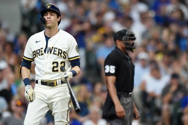 Christian Yelich of the Milwaukee Brewers reacts after a called strike out in the fourth inning against the Chicago Cubs at American Family Field on...
