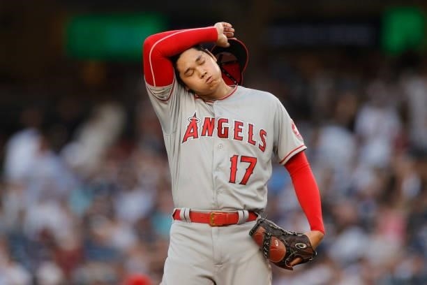 Shohei Ohtani of the Los Angeles Angels reacts after walking Brett Gardner of the New York Yankees and allowing a run during the first inning at...