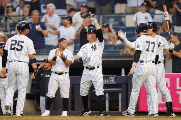 Brett Gardner of the New York Yankees reacts as he, Gleyber Torres, and Clint Frazier score off of a 3-RBI double hit by DJ LeMahieu during the first...