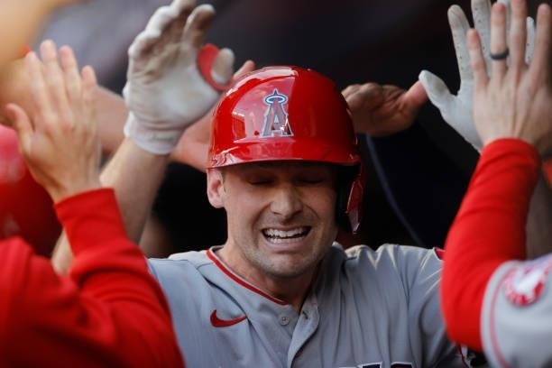 Phil Gosselin of the Los Angeles Angels is congratulated by teammates after hitting a two-run home run during the first inning against the New York...