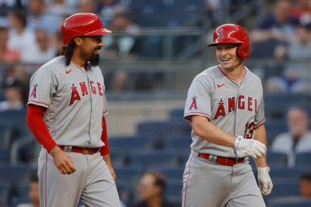 Phil Gosselin reacts with Anthony Rendon of the Los Angeles Angels after Gosselin's two-run home run during the first inning against the New York...