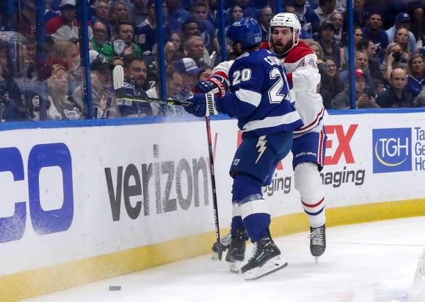 Blake Coleman of the Tampa Bay Lightning collides with Joel Edmundson of the Montreal Canadiens during the first period in Game Two of the 2021 NHL...