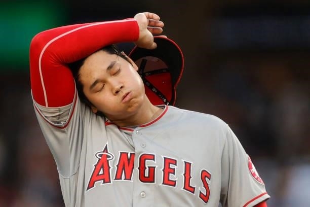 Shohei Ohtani of the Los Angeles Angels reacts after walking Brett Gardner of the New York Yankees and allowing a run during the first inning at...