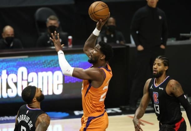 Deandre Ayton of the Phoenix Suns attempts a shot between Marcus Morris Sr. #8 and Paul George of the LA Clippers during the first half in Game Six...
