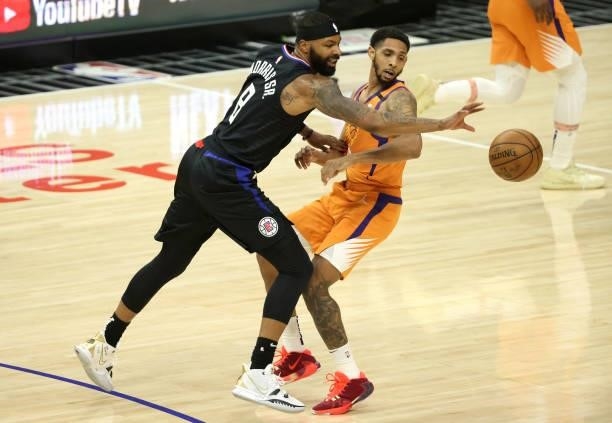Marcus Morris Sr. #8 of the LA Clippers is fouled by Cameron Payne of the Phoenix Suns during the first half in Game Six of the Western Conference...