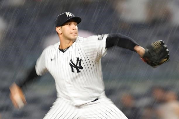 Luis Cessa of the New York Yankees pitches in the rain during the fifth inning against the Los Angeles Angels at Yankee Stadium on June 30, 2021 in...