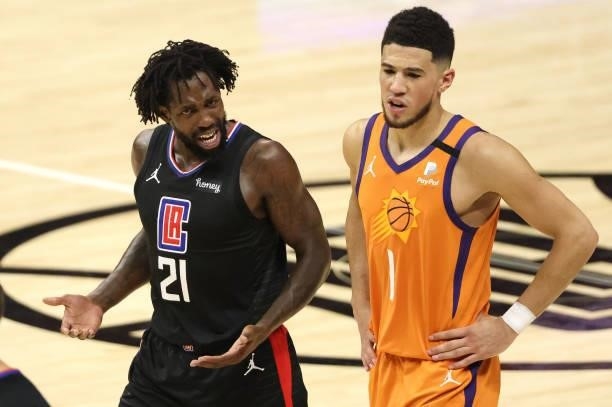 Patrick Beverley of the LA Clippers reacts against Devin Booker of the Phoenix Suns during the first half in Game Six of the Western Conference...