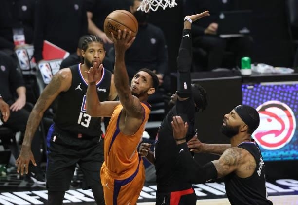 Cameron Payne of the Phoenix Suns goes up for a shot against Reggie Jackson and Marcus Morris Sr. #8 of the LA Clippers during the first half in Game...