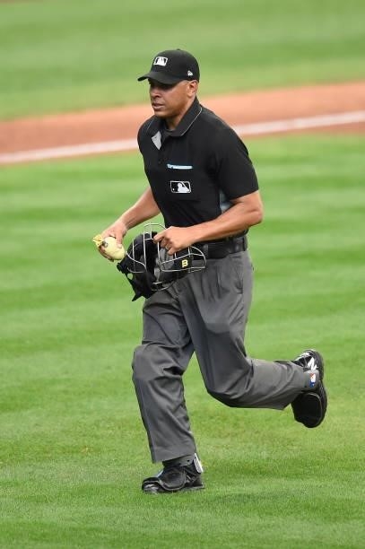 Home plate umpire Jeremie Rehak tosses out the rosin bag that Miguel Sanchez of the Milwaukee Brewers was using during the second inning against the...