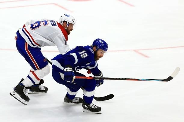Barclay Goodrow of the Tampa Bay Lightning skates against Shea Weber of the Montreal Canadiens during the third period in Game Two of the 2021 NHL...