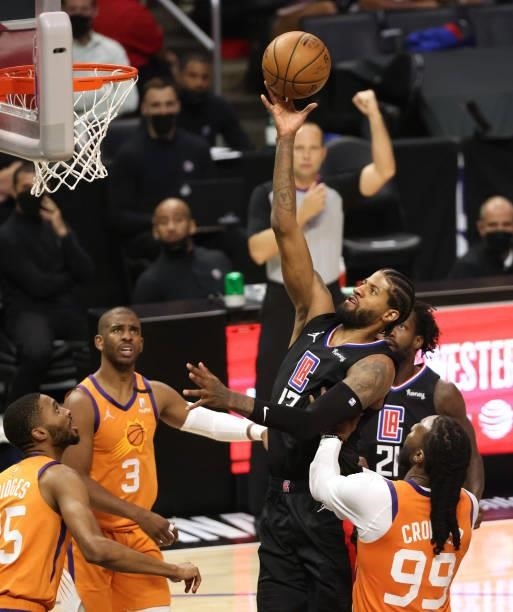 Paul George of the LA Clippers attempts a shot while being fouled by Jae Crowder of the Phoenix Suns during the second half in Game Six of the...