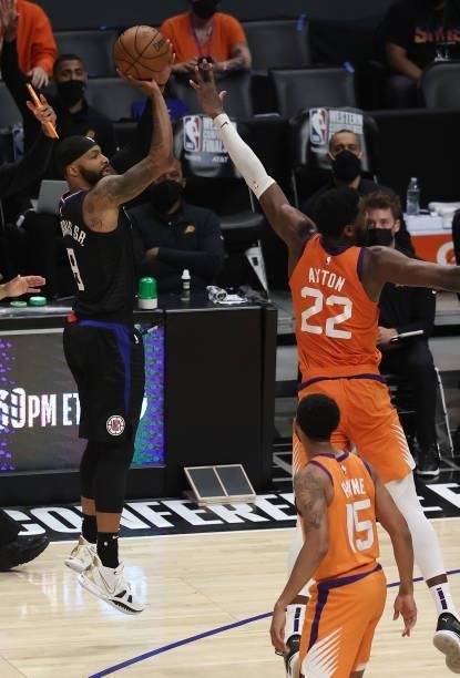 Marcus Morris Sr. #8 of the LA Clippers shoots against Deandre Ayton of the Phoenix Suns during the second half in Game Six of the Western Conference...