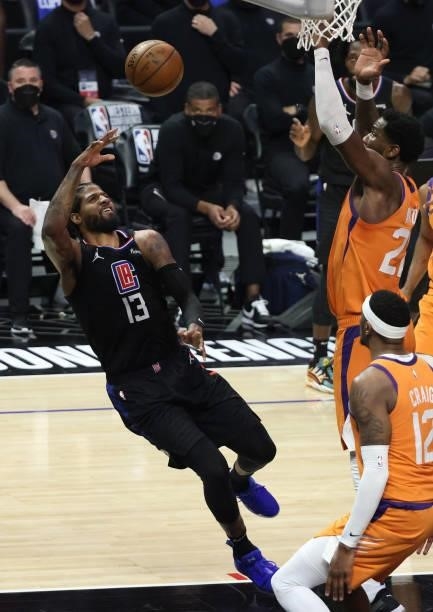 Paul George of the LA Clippers attempts a shot after being fouled by Deandre Ayton of the Phoenix Suns during the second half in Game Six of the...