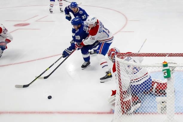Blake Coleman of the Tampa Bay Lightning is defended by Jesperi Kotkaniemi of the Montreal Canadiens as Carey Price tends net during the first period...