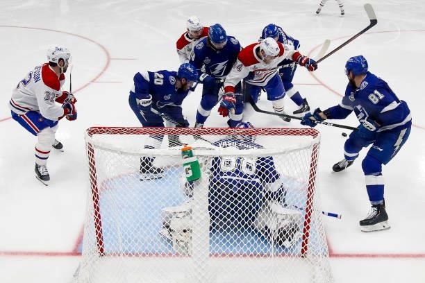 The Tampa Bay Lightning and Montreal Canadiens battle for the puck in front of Andrei Vasilevskiy during the second period in Game Two of the 2021...