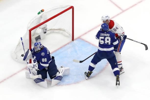Andrei Vasilevskiy of the Tampa Bay Lightning makes the save against as David Savard checks Corey Perry of the Montreal Canadiens during the second...
