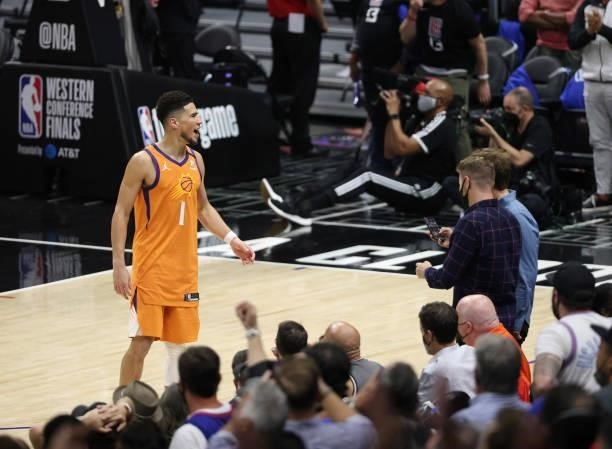 Devin Booker of the Phoenix Suns taunts the crowd against the LA Clippers during the second half in Game Six of the Western Conference Finals at...